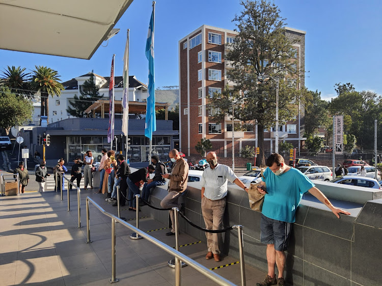 Queues of liquor shoppers outside Checkers Liquors in Cape Town CBD.