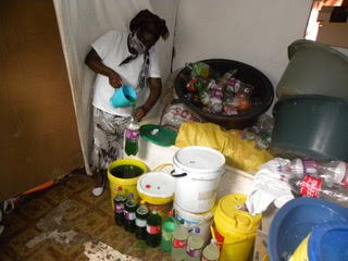 A trader pours detergent into bottles in her house for sale in Nelson Mandela Bay townships.