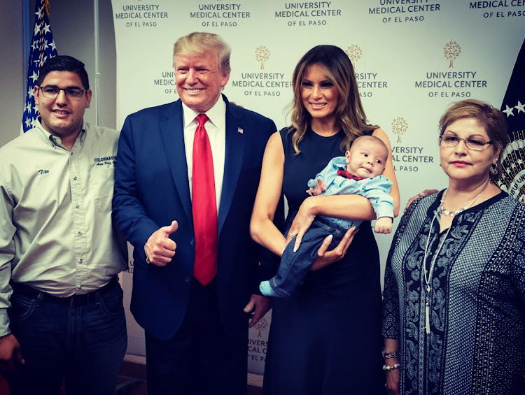 The image of the smiling Donald Trump giving a thumbs-up sign next to a baby orphaned in the El Paso shooting has outraged many.