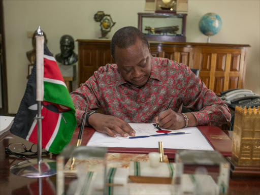 President Uhuru Kenyatta during the signing of key bills at State House, Nairobi. /FILE