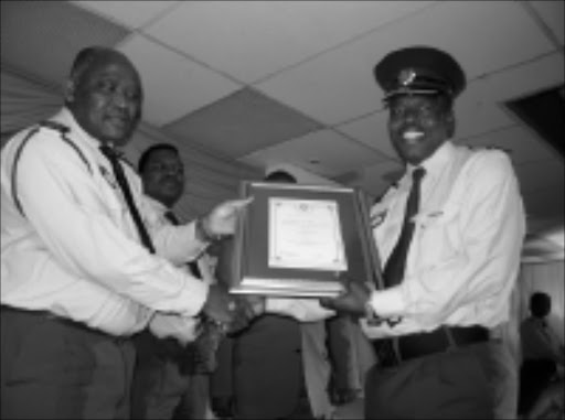SUPERCOP: The late Superintendent Zethembe Chonco, right, recieving an award from KwaZulu- Natal commissioner Hamilton Ngidi earlier this year , while deputy commissioner Fani Masemola looks on. Chonco was murdered in an ambush on Wednesday. Pic. Paul Magwaza. 28/08/2008. © Unknown