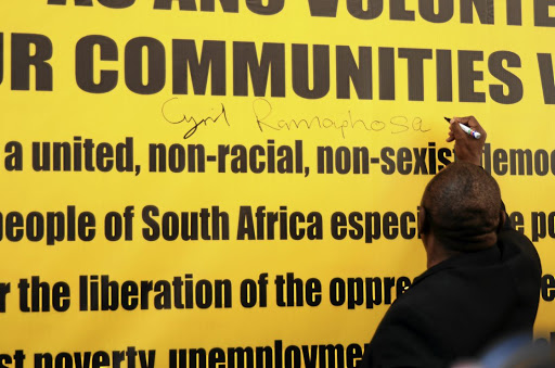 President Cyril Ramaphosa puts his signature on a banner outside Luthuli House yesterday before unveiling the Thuma Mina Campaign, which will eventually be rolled out around the country.