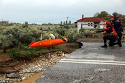 Rescuers transfer a chronic kidney disease patient over a collapsed bridge in a flooded area, as storm Daniel hits central Greece, in the village of Kala Nera, near Volos, Greece, September 6, 2023. 