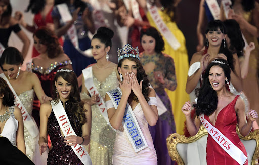 Rolene Strauss of South Africa (C) is crowned Miss World 2014, as Elizabeth Safrit of the U.S. (R) and Edina Kulczar of Hungary (L) who placed third and second respectively, look on at the ExCel Centre in east London, December 14, 2014. Contestants from 126 countries are in London to compete in the 2014 Miss World competition, the 63rd time the annual event has taken place. Picture Credit: Toby Melville/REUTERS