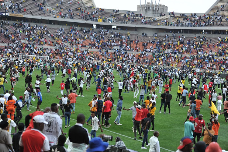 Orlando Pirates fans storm the pitch after their team's 3-0 MTN8 semifinal second leg victory against Mamelodi Sundowns at Peter Mokaba Stadium in Polokwane on October 22 2022.