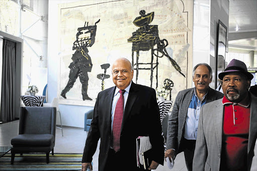 ROAD WARRIORS: Finance Minister Pravin Gordhan briefed the media yesterday on his investor roadshow to London and the US last week. In Gordhan's overseas team were Cas Coovadia, MD of the Banking Council of SA, centre, and Telkom chairman Jabu Mabuza, right