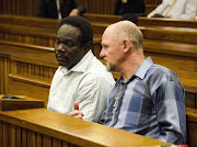Ambrose Monye and Andre Gouws at the Pretoria Magistrates Court on July 1, 2013, in Pretoria, South Africa. Monye and Gouws are accused of the murder of Chanelle Henning, alleged hired hands of her ex-husband. The murder took place in November 2011 after Henning dropped her son of at pre-school.
