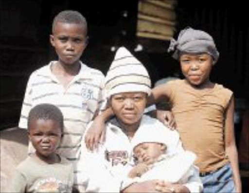 ORDINARY DAY: Kedisaletso Monchusi with her baby, Tebogo, amd her children Otlotleng, Tut and Mosimanegape during an interview with Sowetan at the Princess Crossing informal settlement Roodepoort. Pic. Antonio Muchave. 26/12/2007. © Sowetan.
