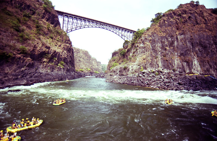 Paddle rafts float under the Victoria Falls bridge and down the Batoka Gorge. Picture: PAUL ASH