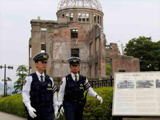 Police officers guard in front of the Atomic Bomb Dome at Peace Memorial Park in Hiroshima, Japan May 27, 2016.