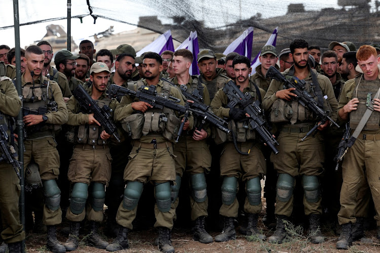 Israeli soldiers listen to Israel's defence minister Yoav Gallant as he meets them in a field near Israel's border with the Gaza Strip, in southern Israel October 19 2023. Picture: RONEN ZVULUN/REUTERS