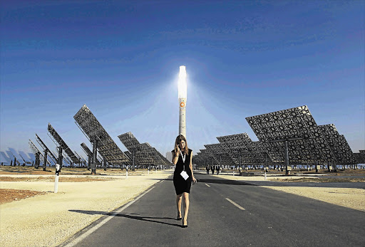 A woman walks at the new solar power plant Gemasolar in Fuentes de Andalucia, southern Spain.