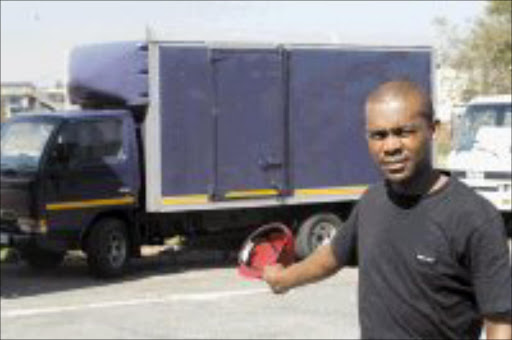 WHEELER DEALER: Thabo points to the unreliable and joined truck his sister Sini Pooe bought from Wall Street Projects. Pic. Antonio Muchave. © Sowetan.