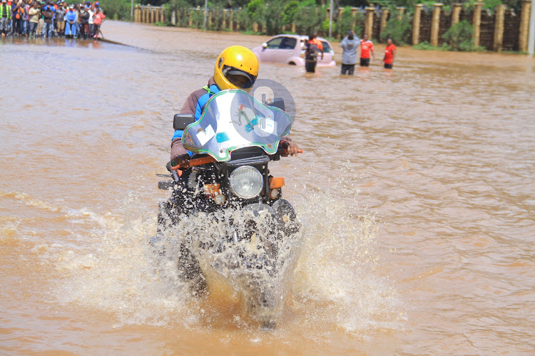 A motorcyclist wades through the flooded section of Thika Superhighway on May 1, 2024.