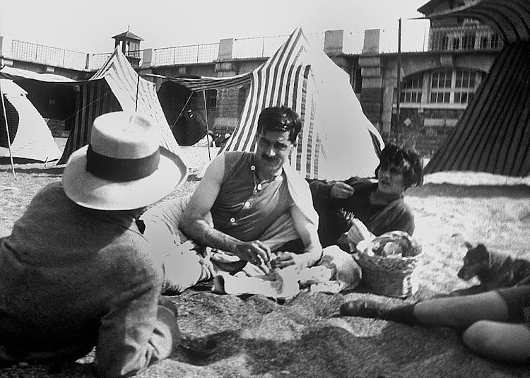 Coco Chanel and her lover Arthur "Boy" Capel (mustache) with Constent Say on the beach in Saint Jean de Luz in 1917.