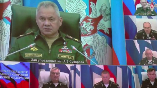 Still from footage shows video link with Defence Minister Sergey Shoygu on big screen and Adm Sokolov immediately below him