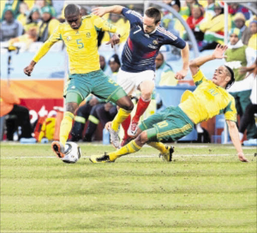 PAYBACK: Bafana players Anele Ngcongca, left, and Steven Pienaar tackle France's Franck Ribery during the World Cup. Funds will be allocated to clubs whose players took part in the tournament. Photo: SYDNEY SESHIBEDI