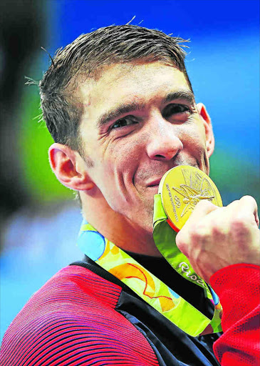 Michael Phelps of United States poses with his Gold medal from the Men's 4 x 100m Freestyle Relay during Day 2 of the Rio 2016 Olympic Games at Olympic Aquatics Stadium. PICTURE: Ian MacNicol/Getty Images