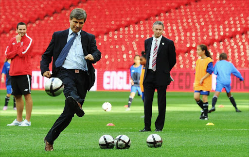 FIFA Chief Inspector Harold Mayne Nicholls takes a penalty shot at Wembley football stadium, London