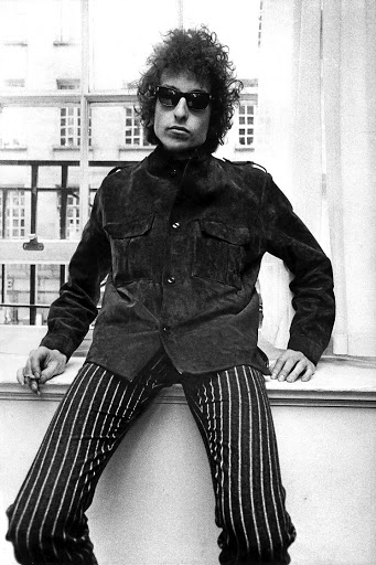 Bob Dylan posing at a press conference at The Savoy.