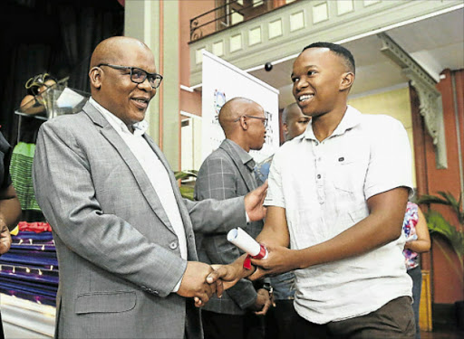 CAREER IN SIGHT: Lumko Qaga receives a bursary from Buffalo City Metro mayor Xola Pakati to study towards a BCom accounting degree at the University of Johannesburg Picture: MARK ANDREWS