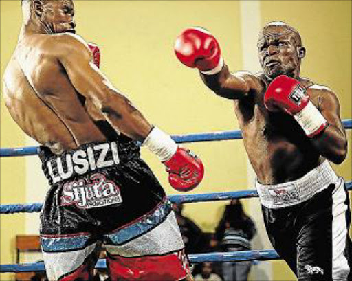 BACKING OFF: Siphiwe Lusizi ducks away from Xayo’s right in their bout