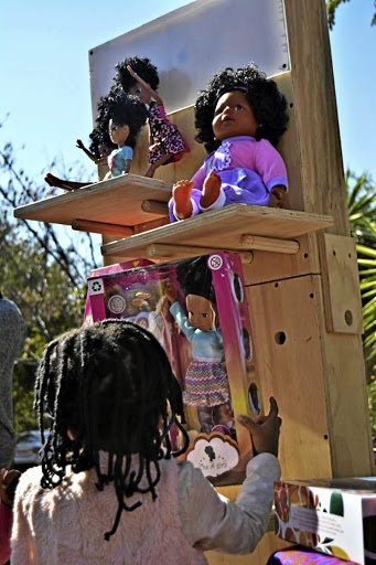 Books and black dolls are also on display at the market.