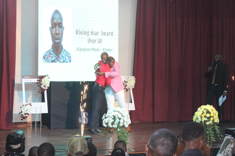 Rising star award over 30 winner Kipng'eno Mutai and Journalist Tony Kwalanda during the Inaugural Content Creator Awards ceremony at the National Museums, Nairobi on April 4, 2024