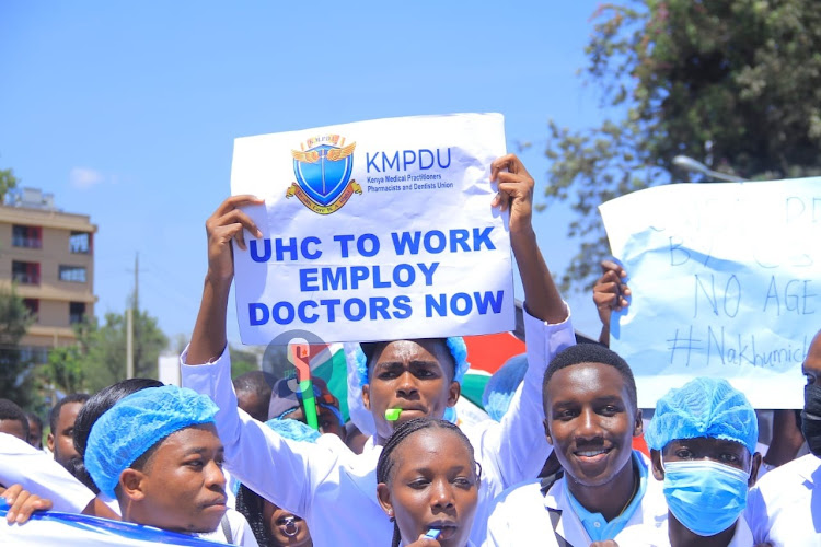 Doctors take to the streets holding placards as they protest over the posting of interns on March 22, 2024.