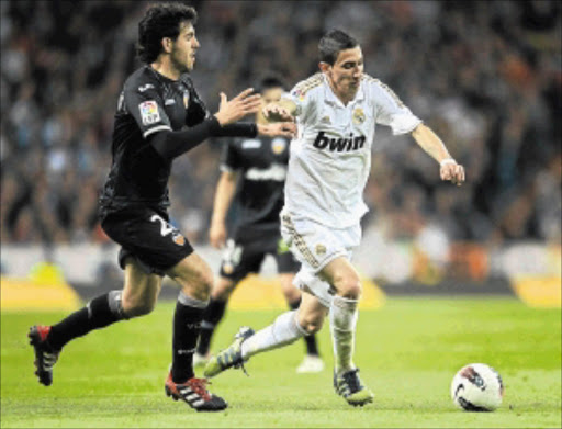 TAKING THE LEAD: Valencia's Daniel Parejo, left, duels for the ball with Real Madrid's Angel Di Maria during their La Liga match at Estadio Santiago Bernabeu at the weekend. Photo: Getty Images