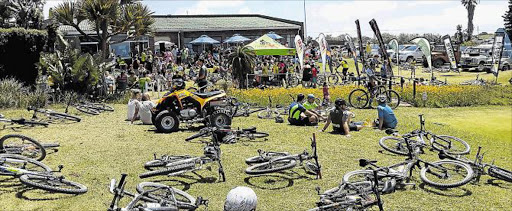 ALL FLAGGED OUT: Cyclists enjoy a well deserved rest at the end of last year’s K2K event