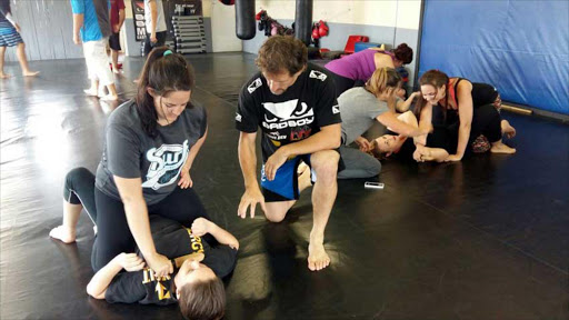 RESISTANCE: East London Martial Arts and Fitness Centre chief instructor Sean O’Connell shows Mikaela Peverett and Stacey Jefferys how to deal with an attacker at a self-defence workshop for women held at the weekend Picture: BARBARA HOLLANDS