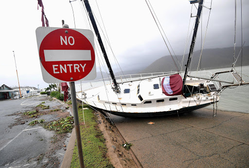 A boat is seen smashed against the bank at Shute Harbour, Airlie Beach. Cyclone Debbie hit Queensland's far north coast as a category 4 cyclone, causing wide spread damage. AAP/Dan Peled/via REUTERS