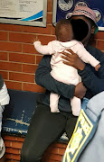 A five-month-old baby girl was reunited with her family after a horrifying ordeal on Tuesday, in which hijackers sped off with her still strapped into her car seat. 