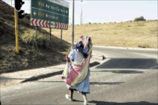 POLE POSITION: Women use children to make money in the streets of Gauteng. Pic. Munyadziwa Nemutudi. 01/07/2009. © Sowetan.