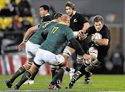 Richie McCaw of the All Blacks fends off CJ Van Der Linde of the Springboks during the recent Tri-Nations match at Westpac Stadium in Wellington, New Zealand. Stats show the All Blacks were on top of everything in this game Picture: PHIL WALTER/GALO IMAGES