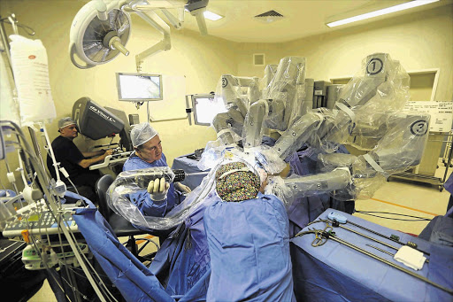 HISTORICAL: Pierre van Vollenhoven (far left) and Dr Gawie Bruwer (right), the South African urologists doing robotic surgery using the Da Vinci at the Durbanville Mediclinic in Cape Town