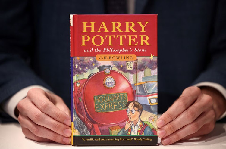 A person holds a rare first edition and signed by the author copy of 'Harry Potter and the Philosophers Stone' by British author J.K. Rowling, which is to be put up for sale at Christie's auction house in London, Britain May 31, 2022.