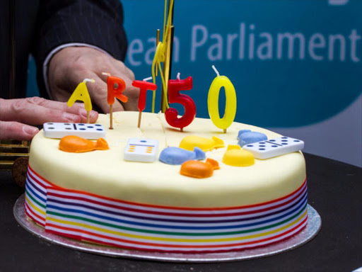 A member of Britain's UK Independence Party (UKIP) posed with cakes celebrating the official triggering of Article 50 of the Lisbon Treaty, the Brexit outside the European Union Council headquarters in Brussels, Belgium March 29, 2017. /REUTERS
