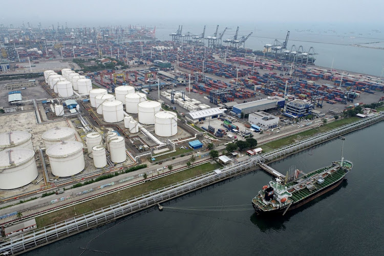 An oil tanker is docked near fuel tanks at Tanjung Priok Port in Jakarta, Indonesia. Picture: BLOOMBERG/DIMAS ARDIAN