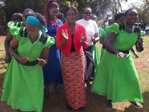 Runyenjes MP Cecily Mbariredances with women when she distributed sh3.7milion Uwezo funds to women, youth and persons living with disabilities'' self help groups. at Runyenjes stadium on Monday April 18 2016