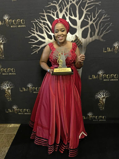 Winnie Mashaba poses with the Best Traditional Gospel Artist award she has won for the third time in a row. / SUPPLIED