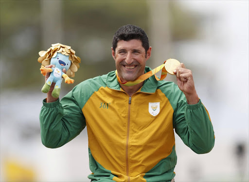 Gold medalist Ernst van Dyk of South Africa poses with his medal. REUTERS/Ueslei Marcelino