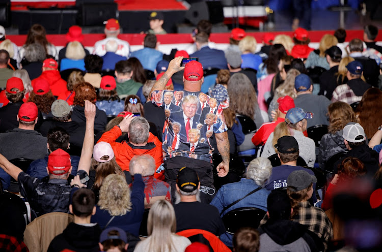 A supporter of Republican presidential candidate and former U.S. President Donald Trump wears a shirt emblazoned with his portraits before his arrival for a rally in Greensboro, North Carolina, U.S., March 2, 2024. Picture: REUTERS/JONATHAN DRAKE/FILE