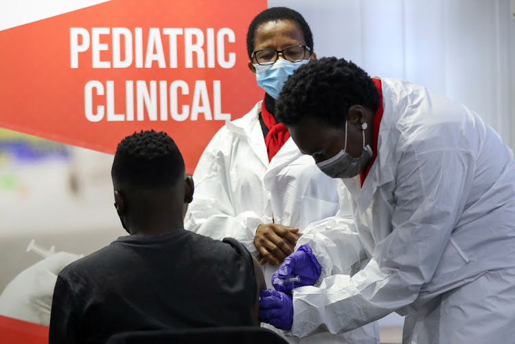 A health worker administers a vaccine during the launch of the SA leg of a global phase III trial of Sinovac's Covid-19 vaccination of children and adolescents, in Pretoria.