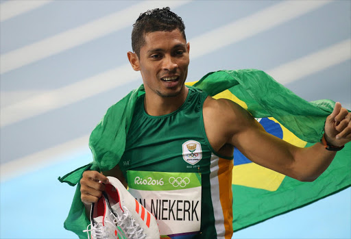 Wayde Van Niekerk of South Africa celebrates winning the gold medal for the men's 400m on day 8 of the Rio 2016 Olympic Games at Olympic Stadium on August 14, 2016 in Rio de Janeiro, Brazil. (Photo by Jean Catuffe/Getty Images)