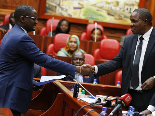 Clerk of the National Assembly Michael Sialai (R) presents NASA Coalition nominee for EALA Kennedy Musyoka the provisional certificate after he presented his credentials at the county hall on November 30, 2017./JACK OWUOR