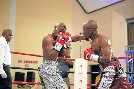 BOMBER: Simphiwe Konkco, right, goes after Nkosinathi Joyi at the Orient Theatre yesterday with a : MARK ANDREWS