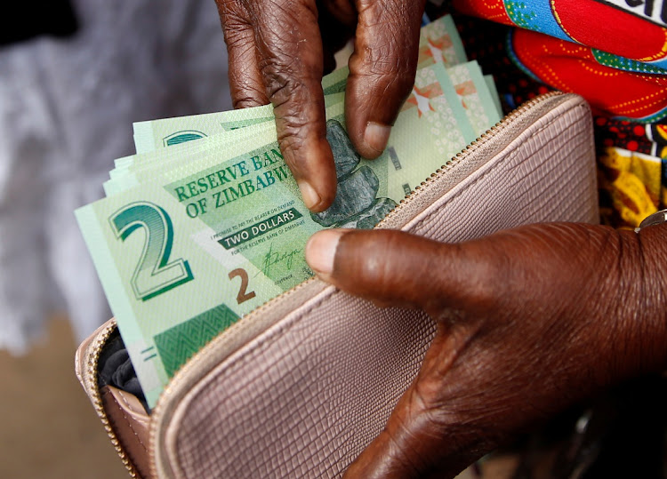 A woman shows Zimbabwe's new banknotes in Harare, Zimbabwe, November 12 2019. Picture: REUTERS/PHILIMON BULAWAYO