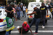 ANC supporters attack a bakkie suspected to be carrying BLF members, outside Luthuli House in Johannesburg on 5 February 2018. 